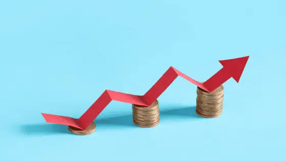 arrows going up above increasing amounts of coins