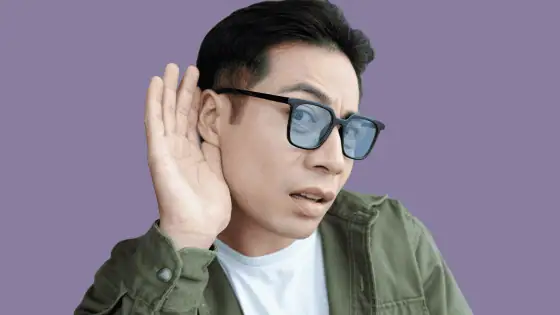 man in glasses cupping his hand around his ear showing TPR