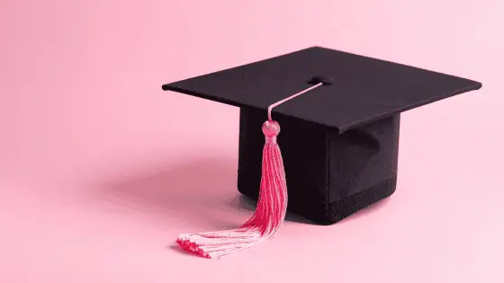 pink background with black graduation hat